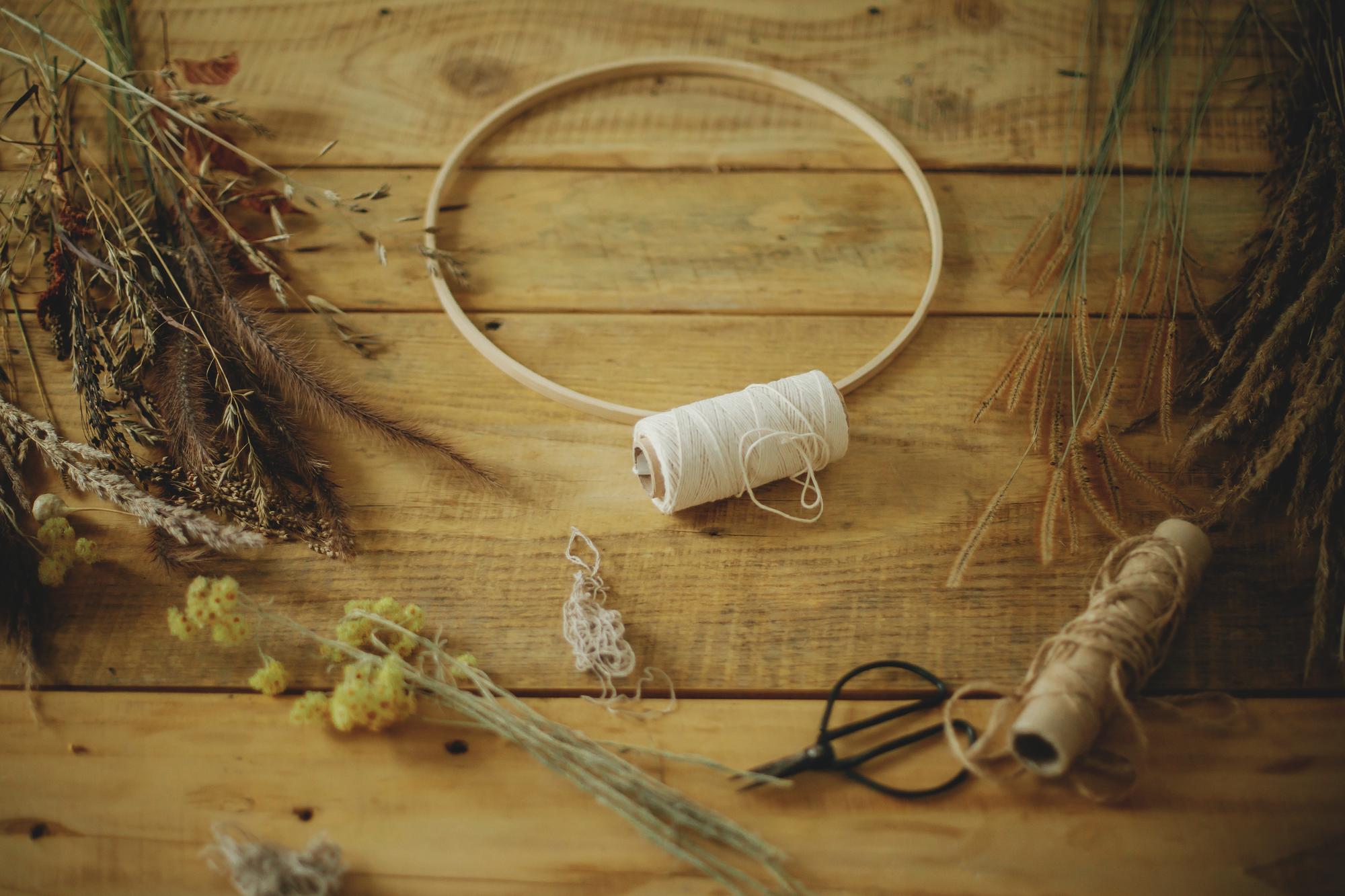 Workspace with threads and an embroidery hoop